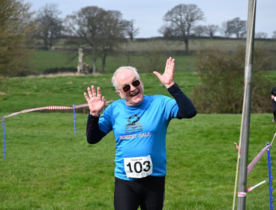 A male runner finishing a race