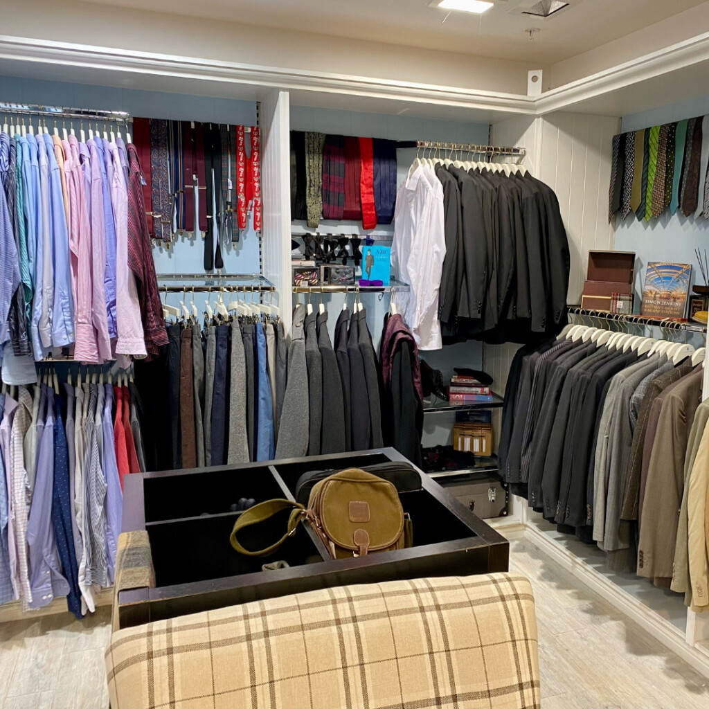 Menswear on rails and racks of clothing inside the pop-up shop.