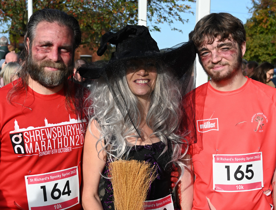 Three people wearing Halloween costumes ready to do the Spooky Sprint.