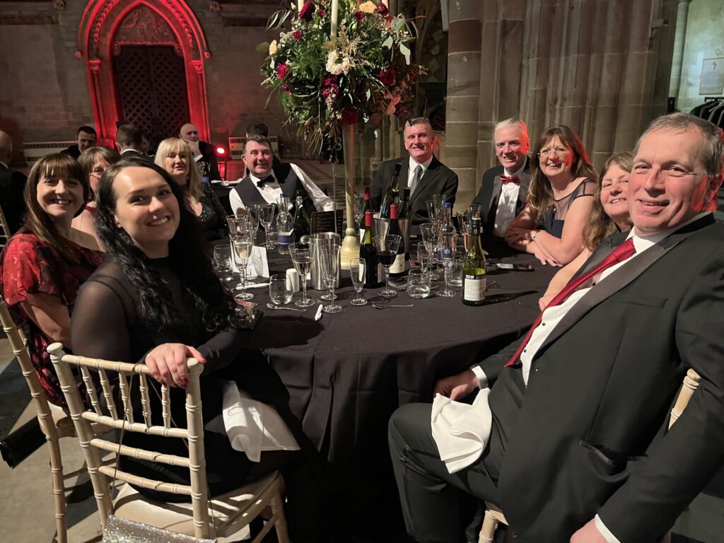 A group of people dressed in evening wear sit around a table at the hospice's Grand Gala Dinner in Worcester Cathedral.