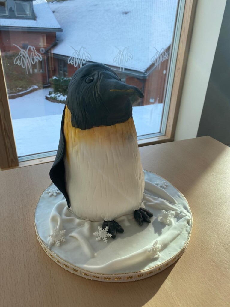 A cake sculpted into the shape of a penguin.