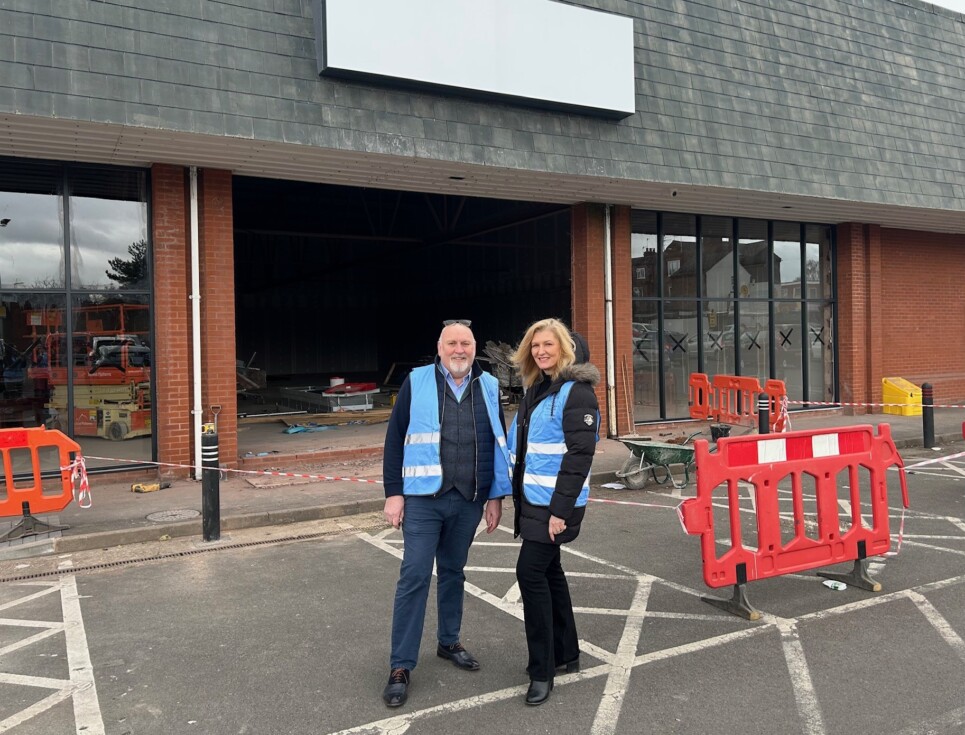 Dan and Abby from the hospice's income generation team stand outside the superstore site which is undergoing extensive building work ready to transform it into the hospice's superstore.